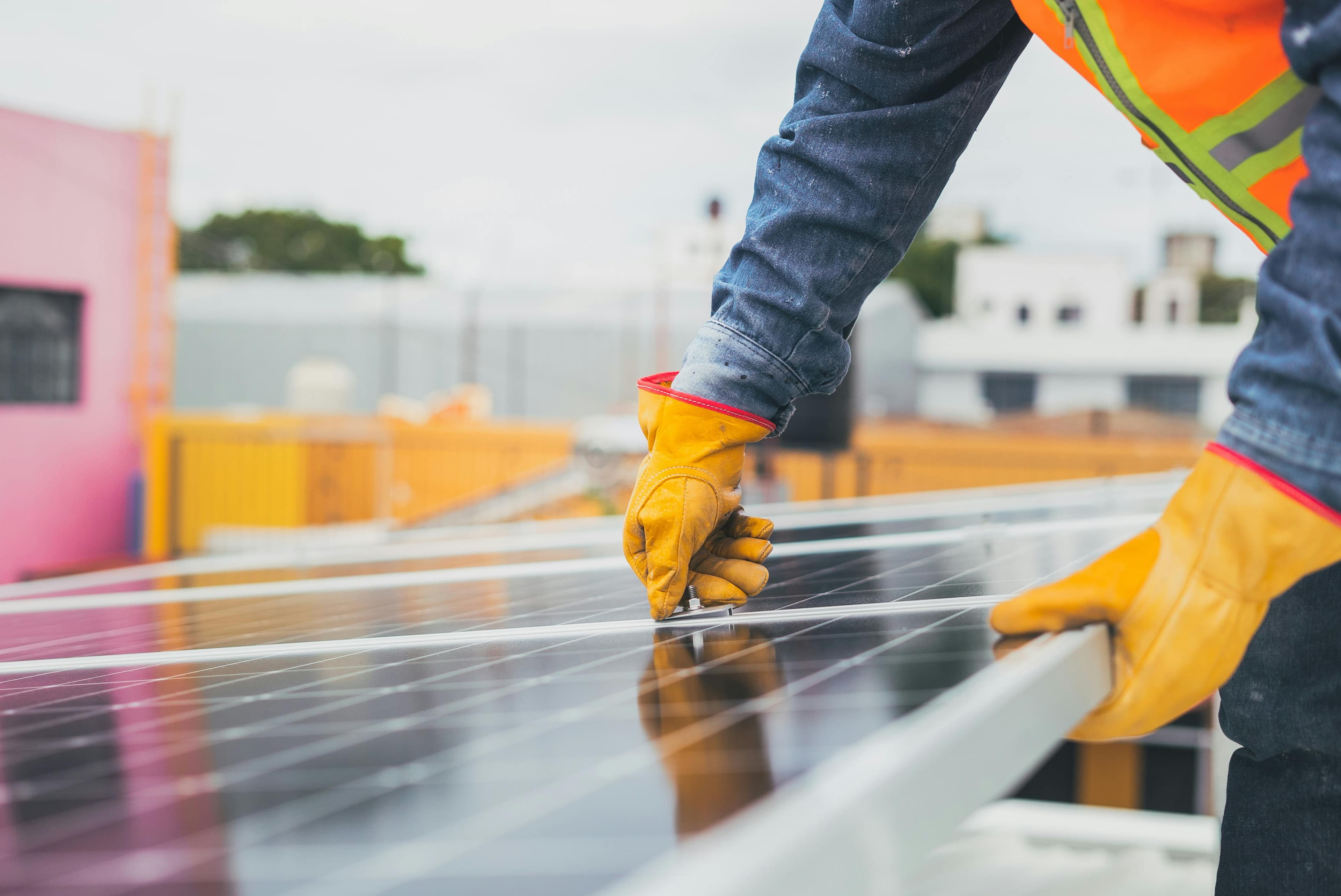 Technician inspecting rooftop solar panels.