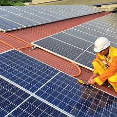 Vehicle charging connector close-up.